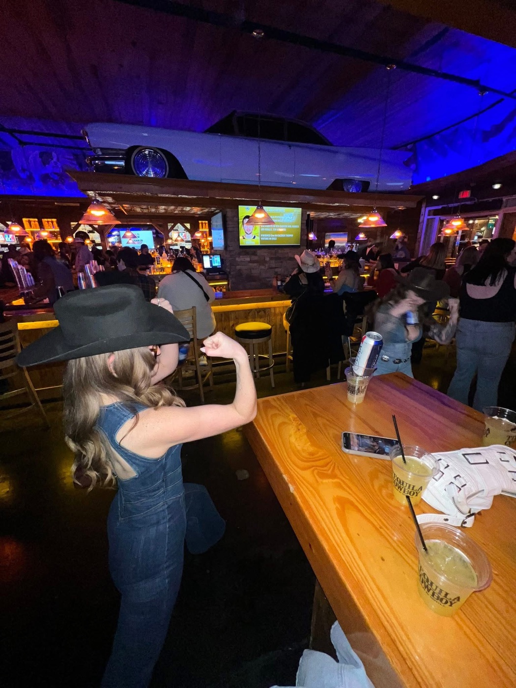 Betties in denim and a black cowboy hat at a Broadway bar