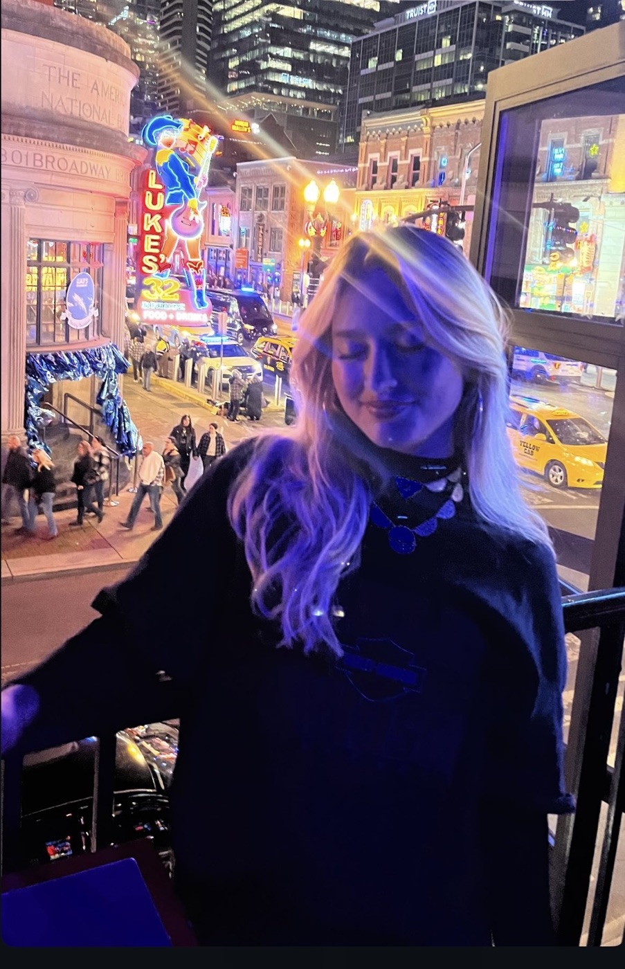 Betties posing above the lights of Lower Broadway